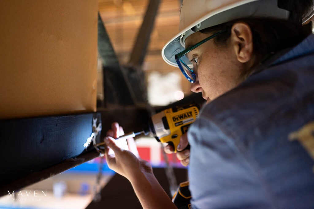 Construction worker photographed installing sound panels