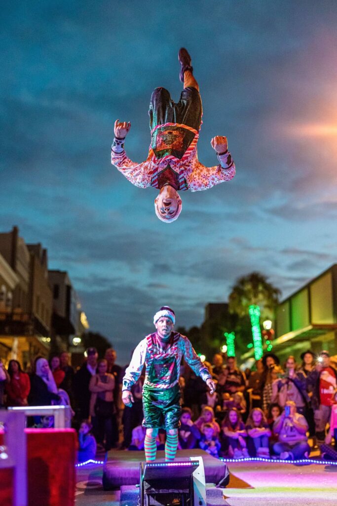 Trapeze artists photographed performing at the Light Up Ocala event.