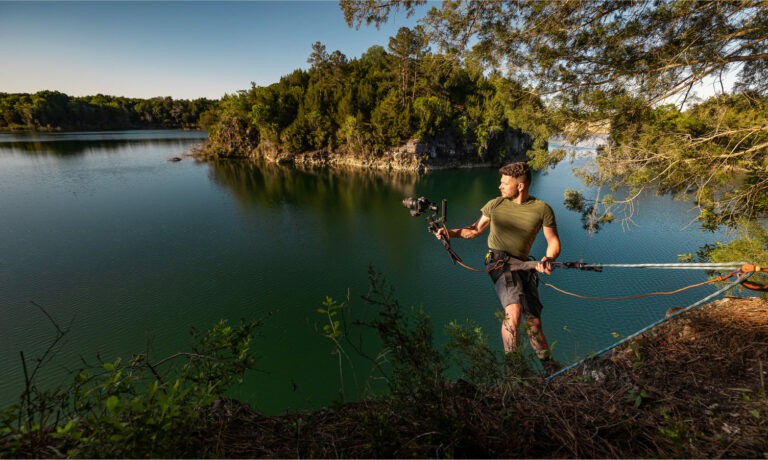 Dave repelling on mountain to get premier footage of lake