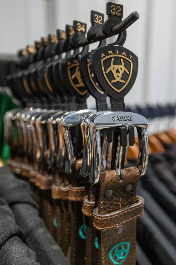 A row of Ariat leather belts featuring a horse logo at World Equestrian Center in Ocala, Florida