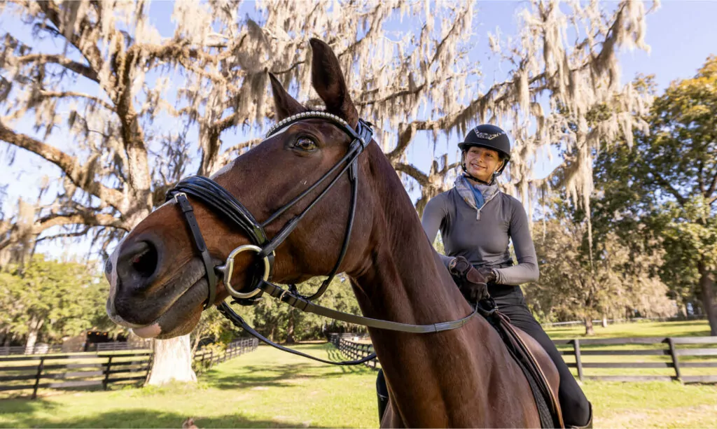 Horse and owner posing for Pegasus Realty photoshoot in Ocala, Florida