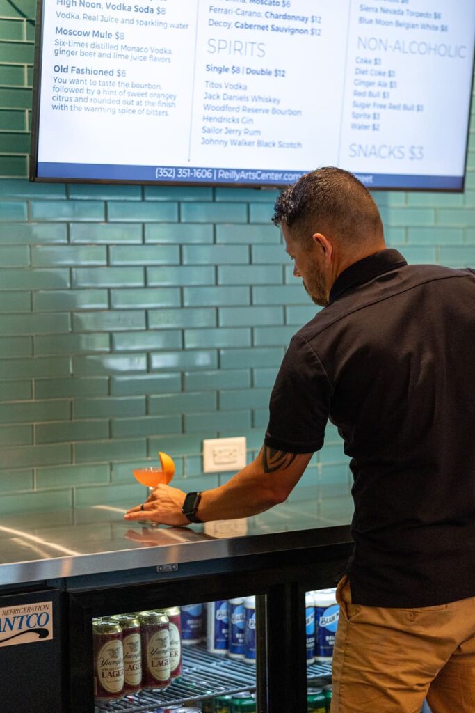 Team Maven positioning a drink on a countertop for a photoshoot.